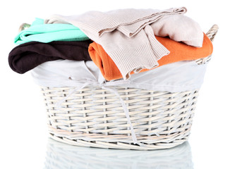 Clothes in wooden basket isolated on white