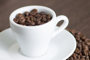 White cup with coffee beans