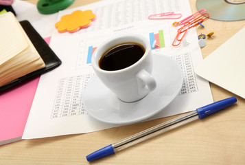 Cup of coffee on office desktop close-up