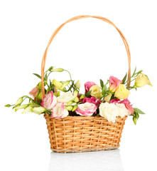 Fototapeta na wymiar Bouquet of eustoma flowers in wicker basket isolated on white