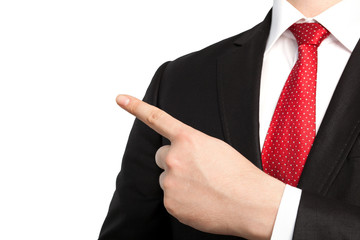 Isolated businessman in a suit and points the finger at an objec