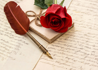 red rose flower, old letters and antique feather pen
