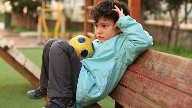 lonely sad sitting a bank, steady cam shoot