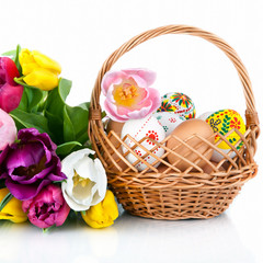 Easter egg decoration in basket and tulip flowers isolated on wh