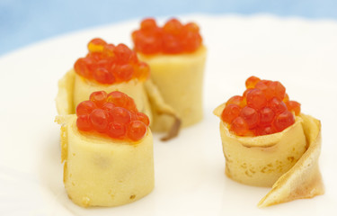 Pancake rolls with red caviar