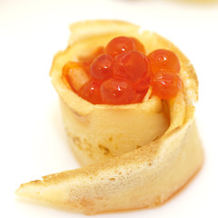 Pancake roll with red caviar close up