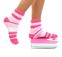 Feet on scales isolated on white