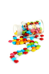 Colorful candies in glass jar isolated on white