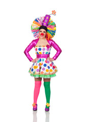 Funny girl clown with a big colorful wig