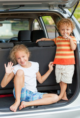 two happy kids in the car