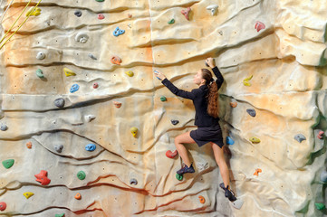 young business woman on rock wall