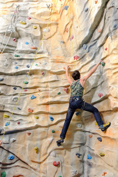 young man on rock wall