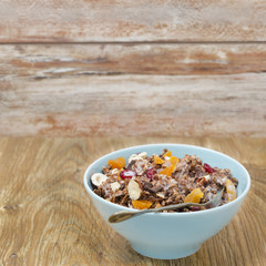 Chocolate granola with nuts and dried fruit and milk
