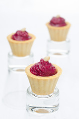 three tartlets with beetroot mousse and goat cheese