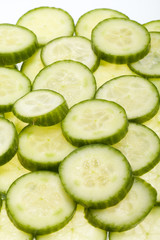 Freshly sliced cucumber  isolated on white background