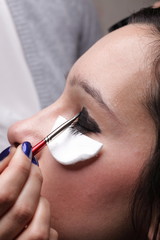 Woman applying eyeshadow makeup brush