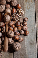 Nuts and spoon on the wooden table