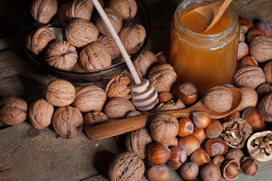 Nuts, spoons and honey on the table