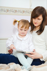 Mother and child reading book