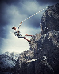 businesswoman climbing mountain
