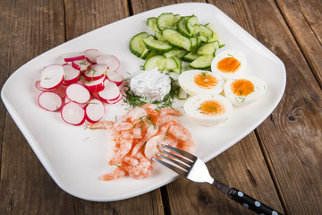 salad with eggs, cucumber, radishes and shripms
