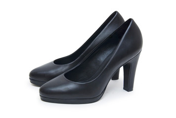 Close-up of female high-heeled shoes over white background