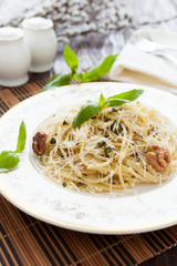 spaghetti with pesto and crushed nuts and parmesan