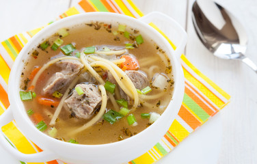 meat soup with pasta in a tureen