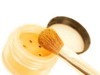 gold make-up eyeshadows and cosmetic brush