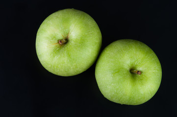 Fresh green apple on black background