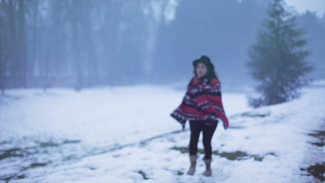Latin woman running in the snow