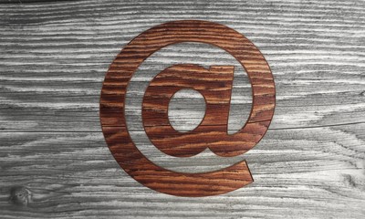 Wooden e mail symbol in a wooden background