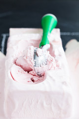 Strawberry ice cream and scoop