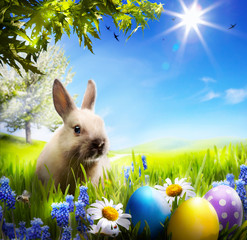 art Little Easter bunny and Easter eggs on green grass