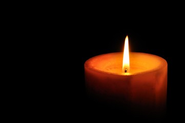 Candle on right of the frame with black background