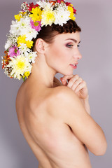 Beautiful girl with mohawk from flowers on her head