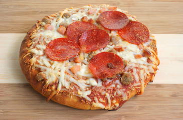 Cooked thick crust pizza on cutting board