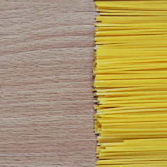 Spaghetti on the wooden background