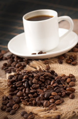 closeup view of a cup of coffee  and coffee beans