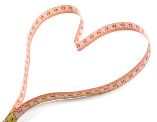 A measuring tape shaping a heart, isolated on white background