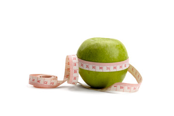 A green apple and a measuring tape