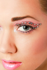 Obraz premium Woman eye with exotic style makeup