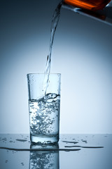 Water is poured into a glass from the filter