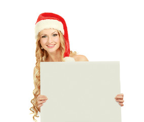 Beautiful christmas woman in santa hat holding