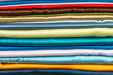 Pile of silk fabric of different colours.