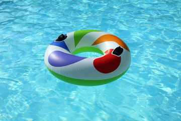 swim ring floating on a blue swimming pool