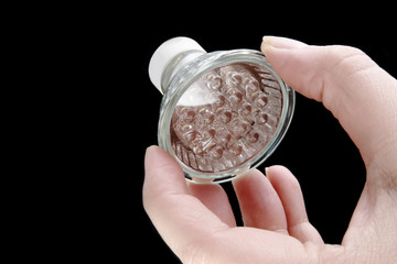 Led bulb in woman's hand on black background
