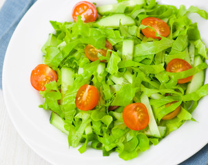 fresh vegetable salad with lettuce, tomato and cucumber