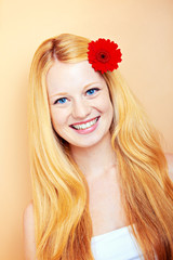 portrait of a young beautiful blonde girl with flower