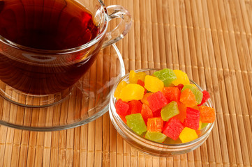 Cup of tea with candied fruits